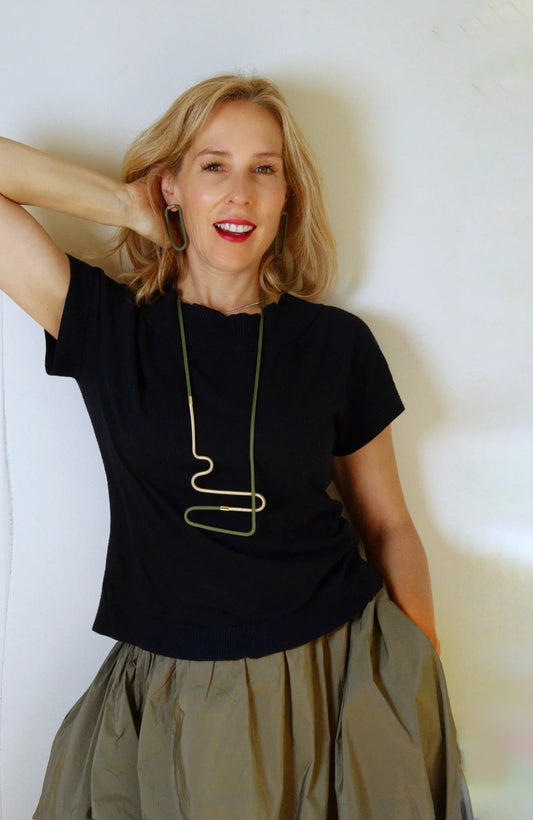 Laetitia wearing Linea 2 necklace in olive and Gold from the Metallic Series Industrial modern jewelry.