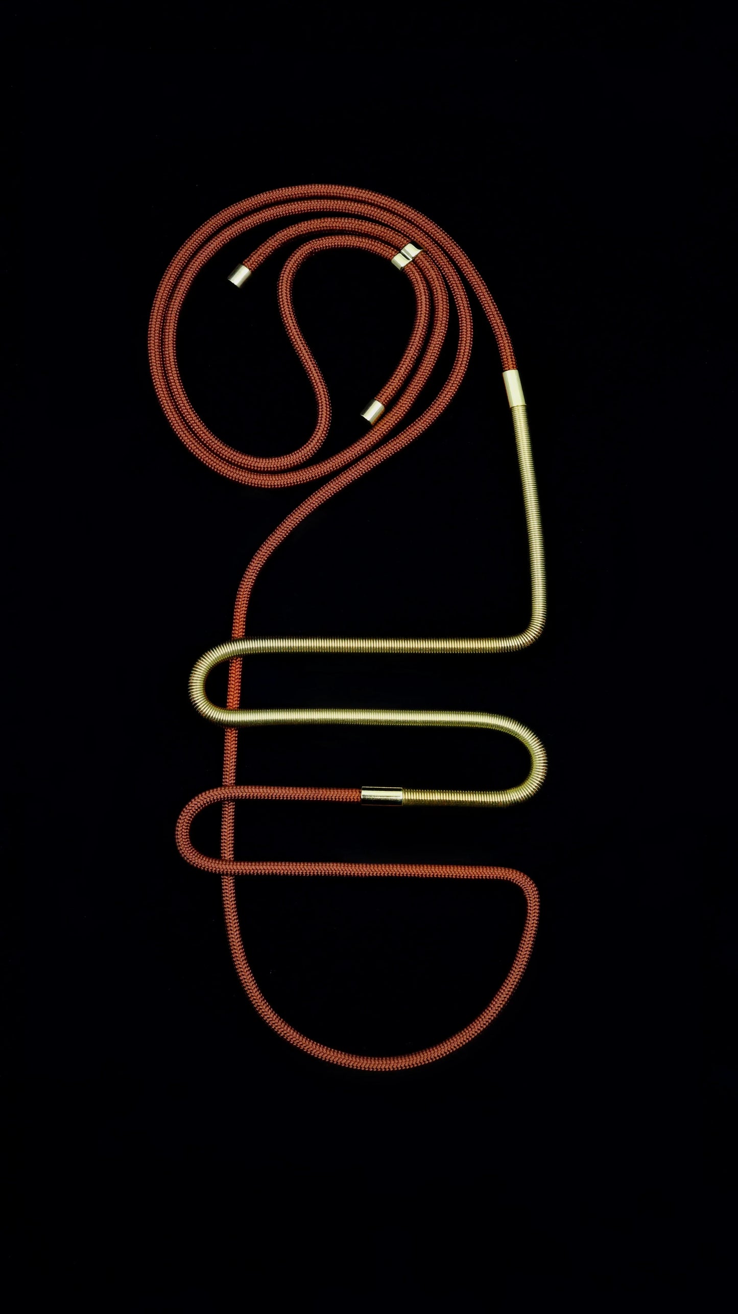 FuturisNow Linea collection necklace with modular red cord and gold tubular sections on black background