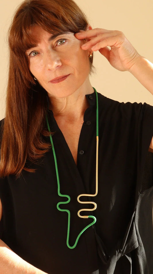 Person wearing a black shirt with a green and gold abstract design.