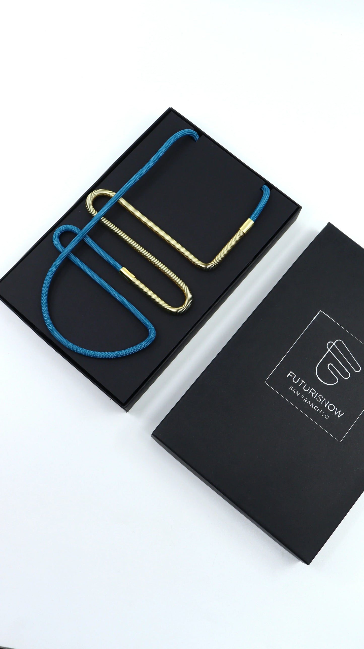 Modern Linea collection necklace with blue cord and gold metal links in black FuturisNow box