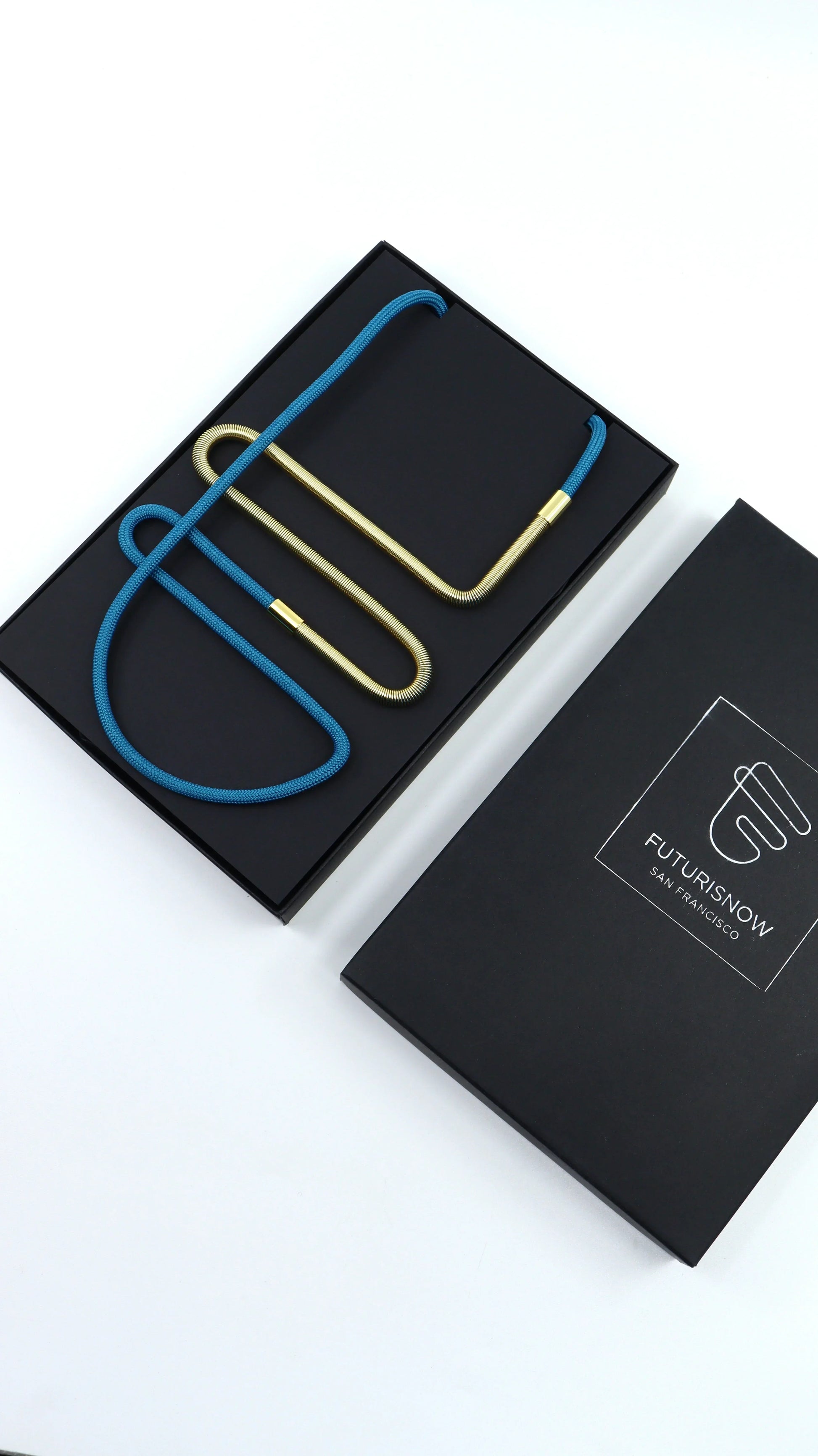 Modern Linea collection necklace with blue cord and gold metal links in black FuturisNow box