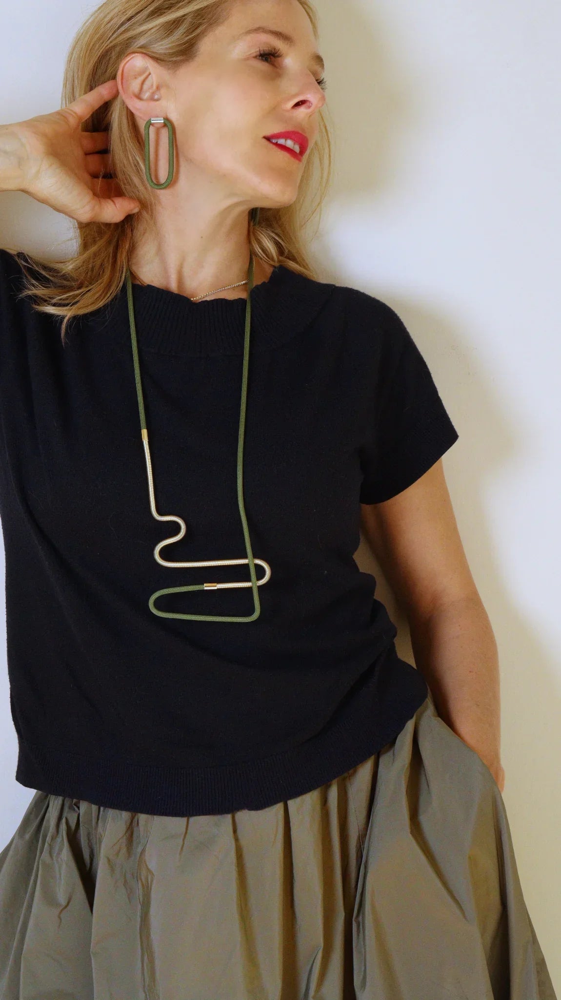 Laetitia wearing Linea 2 necklace in olive and Gold from the Metallic Series Industrial modern jewelry. 