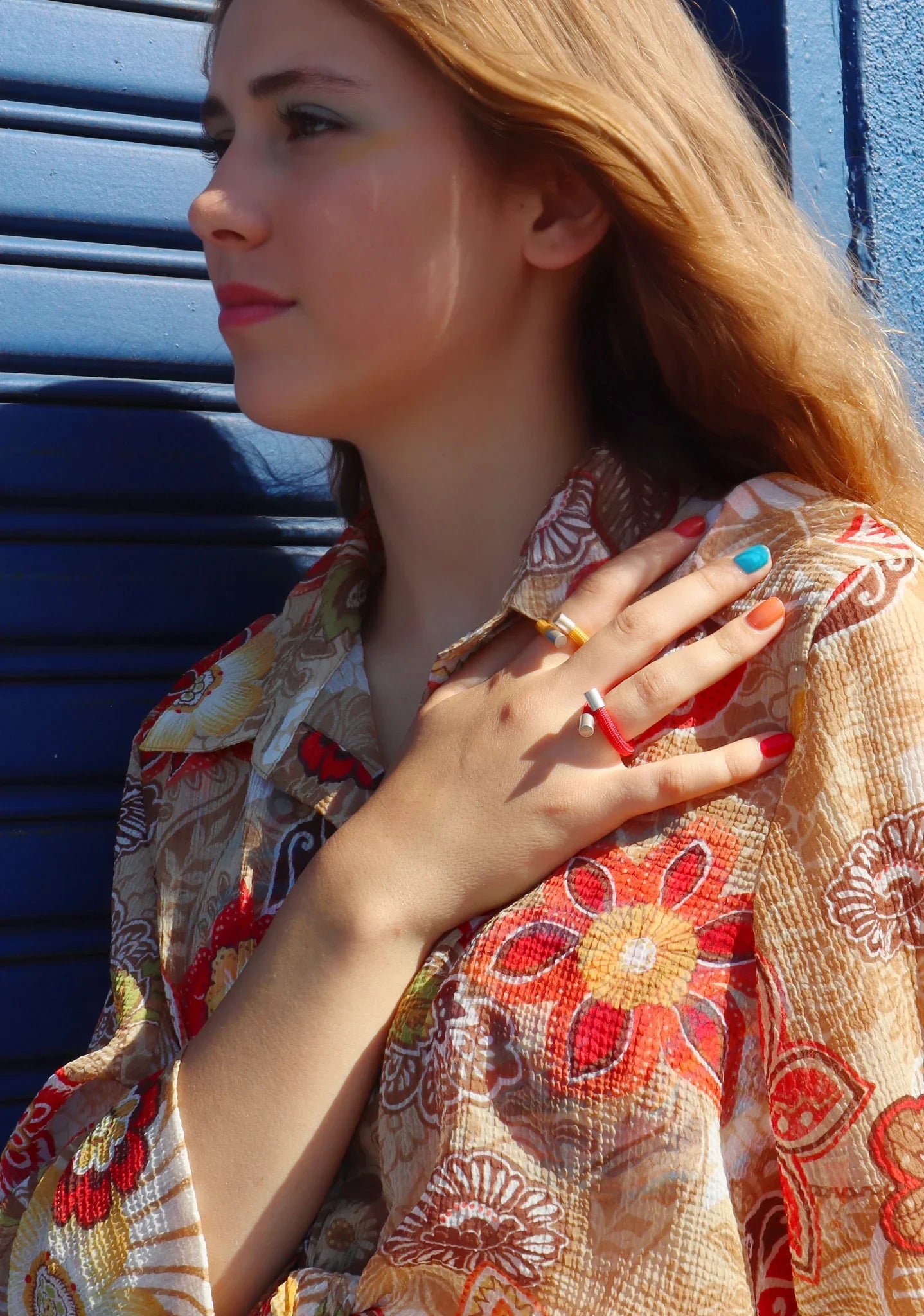 Josephine wearing a set of colorful x rings from futurinow moder jewery