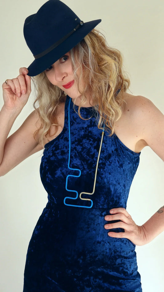 Joe wearing Linea 12 necklace in teal and Gold from the Metallic Series Industrial modern jewelry. 