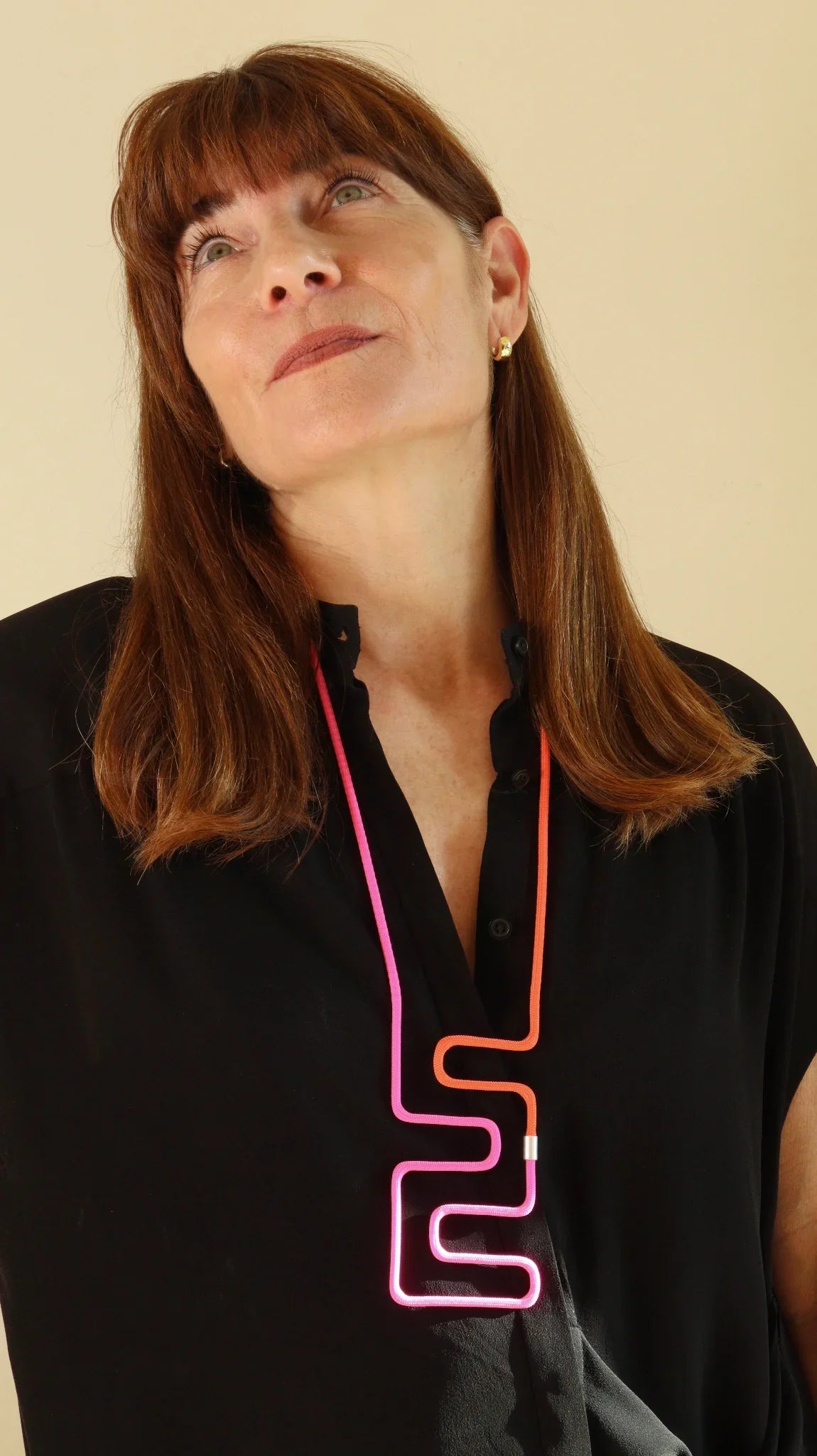 Joelle wearing linea 24 necklace in pink and orange from the multicolor series by futurisnow modern jewelry