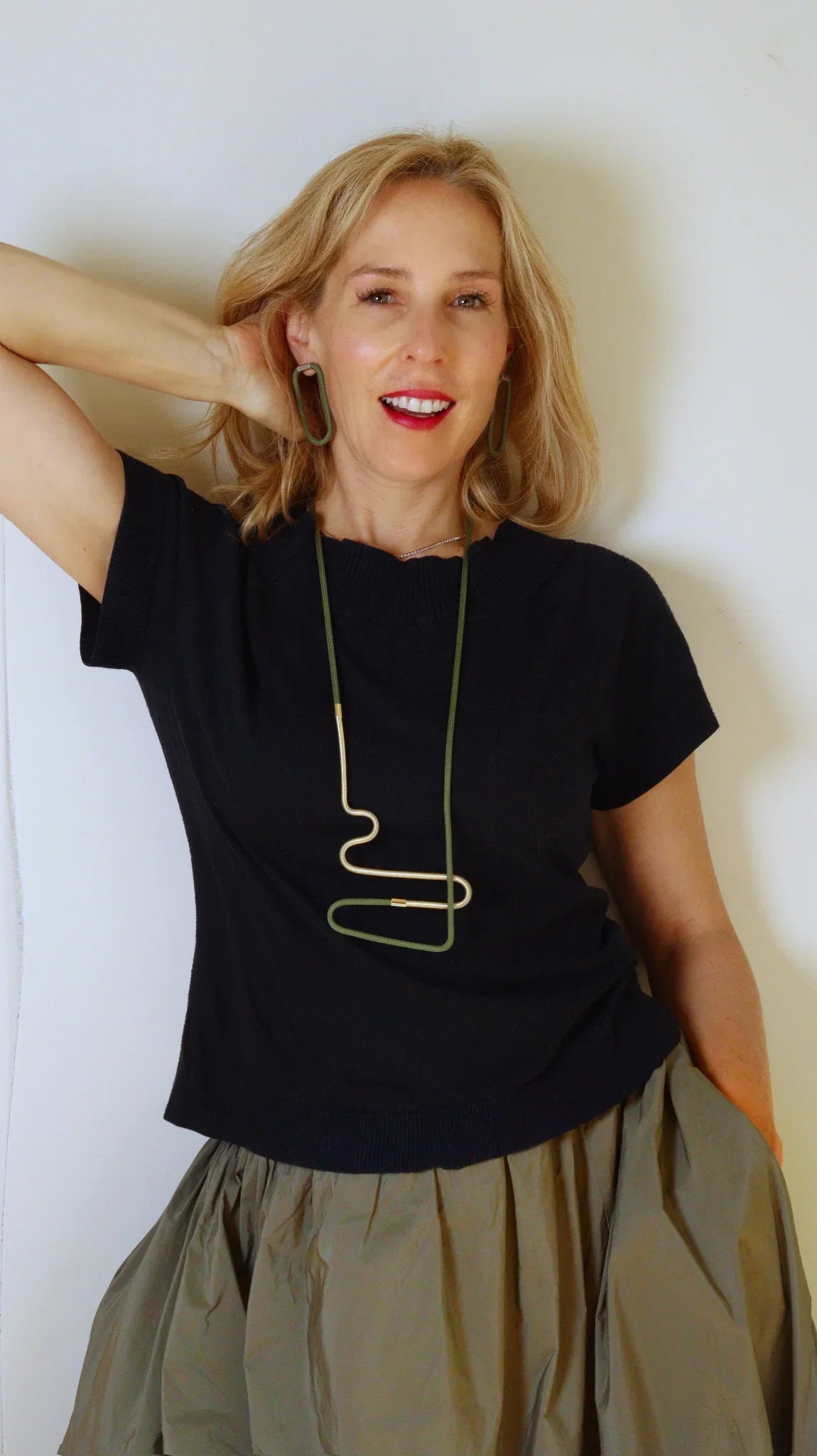 Laetitia wearing Linea 2 necklace in olive and Gold from the Metallic Series Industrial modern jewelry. 