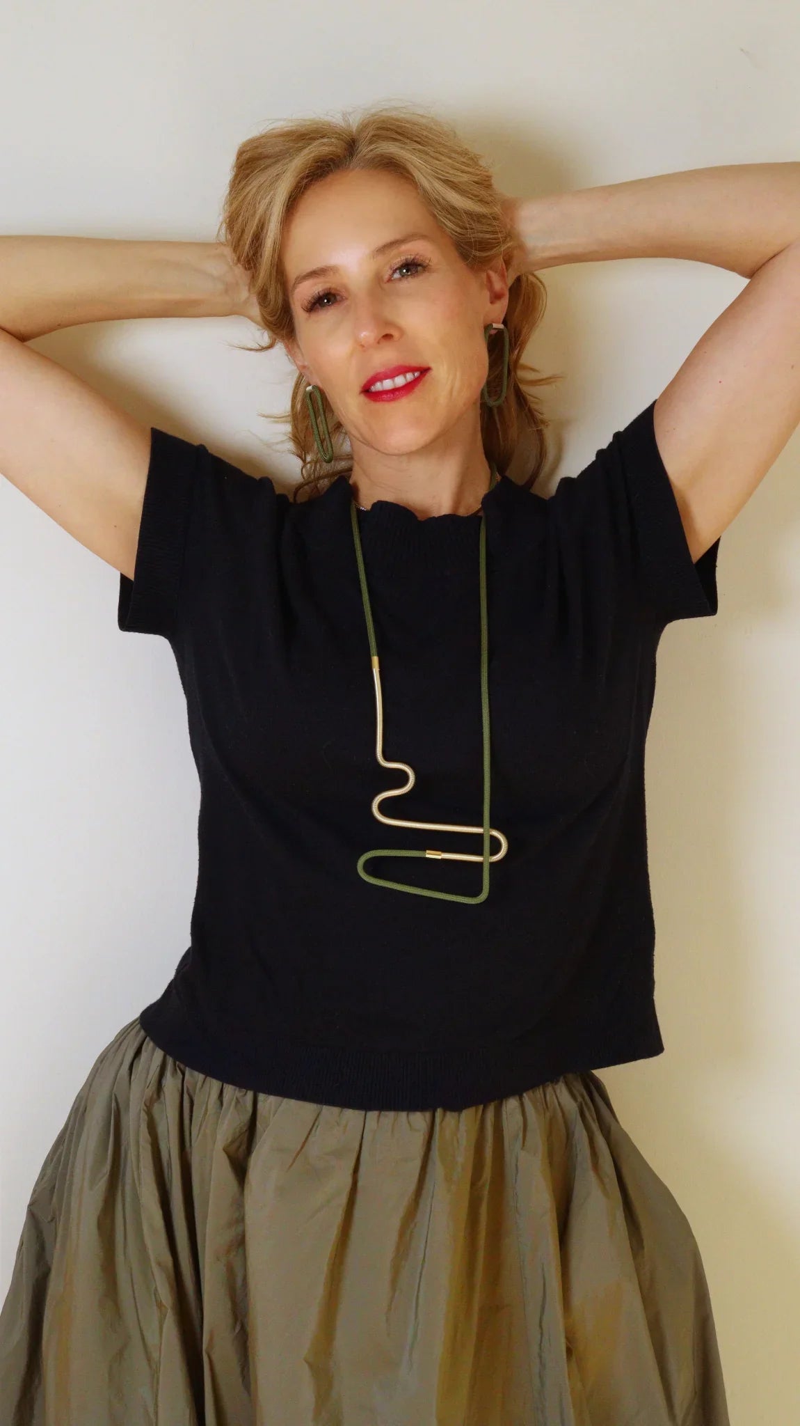 Laetitia wearing Linea 2 necklace in olive and Gold from the Metallic Series Industrial modern jewelry. 