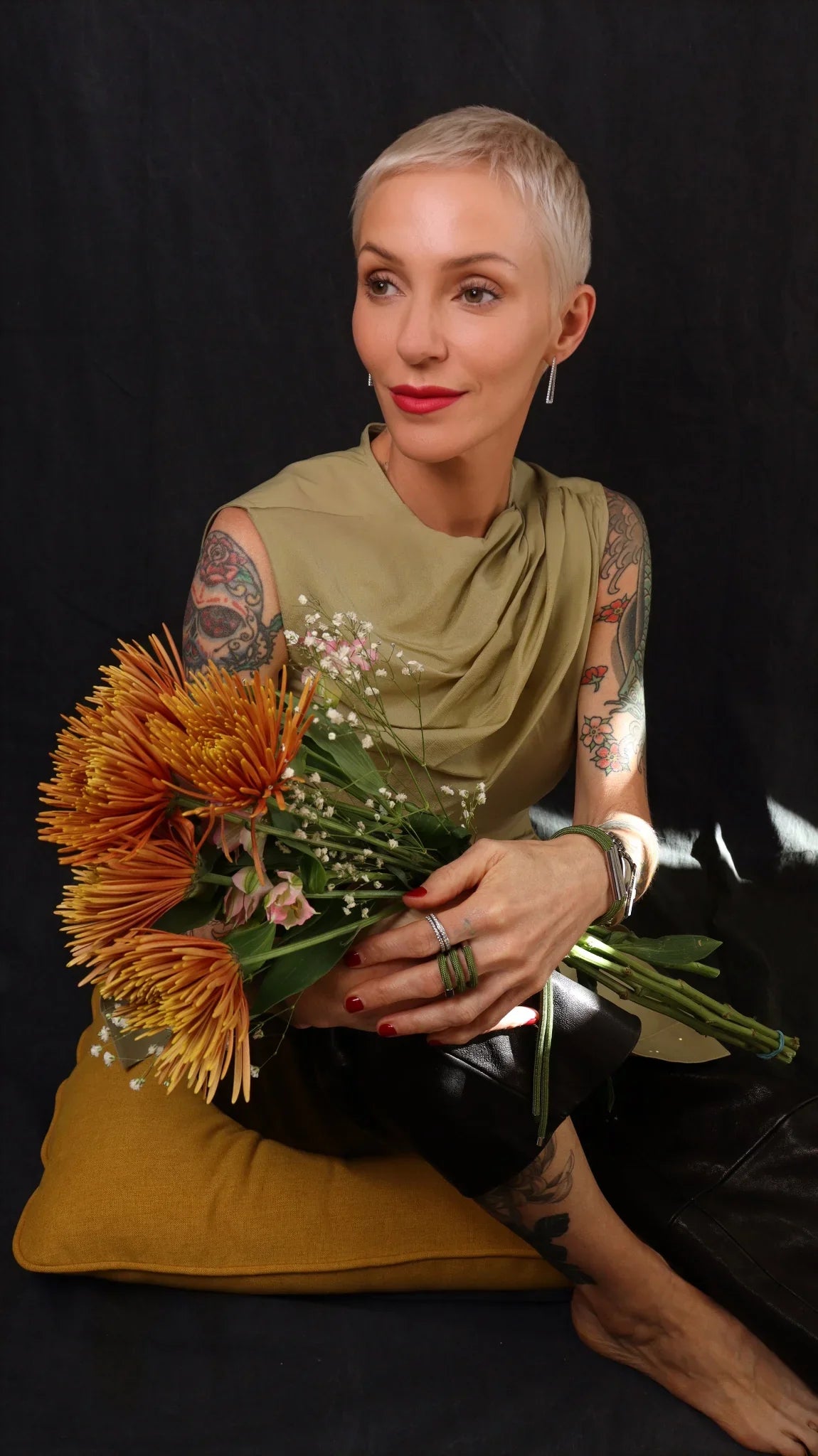 Model wearing twirl bracelet and ring in olive with flowers and tattoos by futurisnow modern jewelry 
